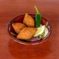 Fried Kibbeh Akkras · 3 pieces. Sauteed ground meat and onions, stuffed in kibbeh made of a cracked wheat ball and...