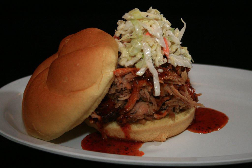 PULLED PORK SANDWICH · Topped with Carolina BBQ sauce, and coleslaw
