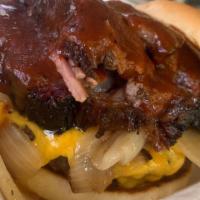 CHIPOTLE BRISKET BURGER · Beef burger, beef brisket, cheddar cheese, grilled onions, Chipotle BBQ sauce 
