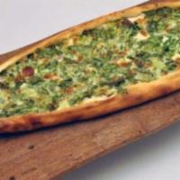 Greek Pide · Our cheese pide topped with spinach and fete cheese.