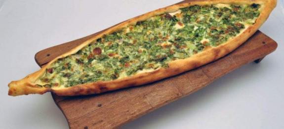 Greek Pide · Our cheese pide topped with spinach and fete cheese.