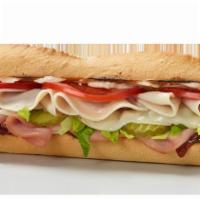 Spicy Monterey Sub · Turkey, ham, provolone, pickles, lettuce, tomatoes, mayo and Batch 83 four pepper chili sauce.