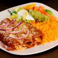 Enchiladas Poblanas · 3 chicken enchiladas topped with mole sauce and cheese, served with lettuce, sour cream, tom...