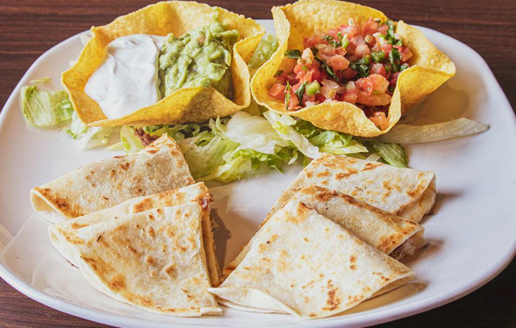 Quesadilla Supreme · A grande quesadilla grilled and stuffed with cheese, shredded beef or chicken. Served with lettuce, guacamole, sour cream and tomatoes.