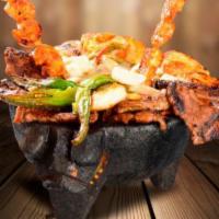 Teresas's Molcajete · Tender slices of steak and chicken grilled with mushrooms, squash, Mexican onions and nopal ...