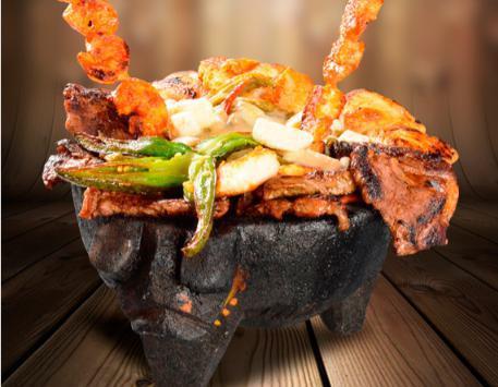 Teresas's Molcajete · Tender slices of steak and chicken grilled with mushrooms, squash, Mexican onions and nopal (cactus) marinated in green sauce and covered with chihuahua cheese. 