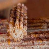 Churros · Mexican pastry sticks deep-fried, rolled in cinnamon and sugar, served with a scoop of ice c...