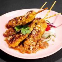 Chicken Satay · Malaysian inspired grilled chicken on skewers with curried peanut sauce & cucumber relish