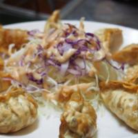 N-67. Fried Dumplings 12 (튀김만두/油炸饺子) · Deep-fried dumplings with pickled radish and cabbage salad. Served 12 pieces.