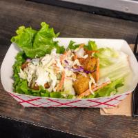 Lettuce Wrap · Pulled chicken adobo with rice, coleslaw and cilantro on leaf lettuce.