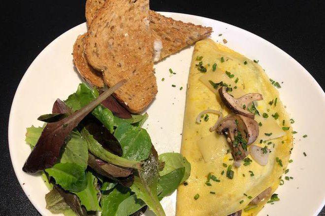 Mushroom Omelette · Stuffed with Mushrooms, Shallots and Swiss Cheese. Topped with Shallots, Herbs, and Truffle Oil.