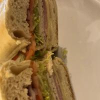 American Sub · Premium ham and all natural roast turkey breast,  swiss, shredded lettuce, tomato and red on...