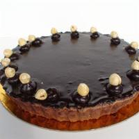 CHOCOLATE HAZELNUT BRULEE TART · Chocolate crust filled with caramel, hazelnut creme brulee, topped with chocolate ganache.
