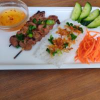Grilled Pork Skewer · Served with rice vermicelli are woven square, roasted peanuts, and scallions.
