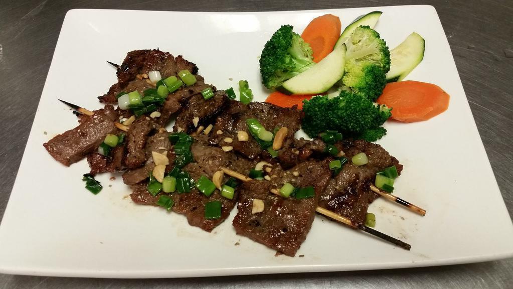Grilled Lemongrass Beef · Marinated Angus sirloin flap beef topped with lemongrass, and options steam vegetables and roasted peanuts.
