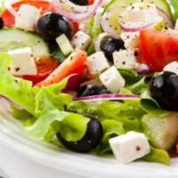 Greek Salad · Mixed greens, tomato, feta, and kalamata olives, tomato and onions.