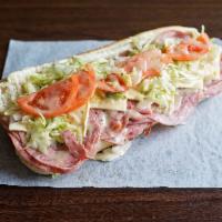 Tubby's Famous Sub · Cotto salami, hard salami and ham. Served cold on fresh bread stacked with quality meats, ch...