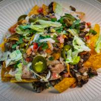 Nachos · Fried corn tortilla chips and a choice of meat. Served with melted cheese dip, refried beans...