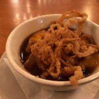 Irish Onion · Rich beef and sweet onion broth slow-cooked and topped with crispy onions and melted sharp c...
