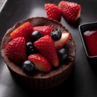 Chocolate Souffle · Chocolate soufflé, fresh berries, raspberry sauce