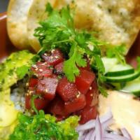 Tuna Poke · Tuna is served raw tossed with furukaki seasoning and a soy based dipping sauce.  Served wit...