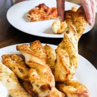 Garlic Parmesan Twists · Rolled fresh daily and baked to perfection with fresh garlic, three-cheese blend and Parmesa...