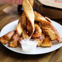 Cinnamon Twists · Our famous twists, rolled in a brown and white sugar cinnamon mixture and topped with a deli...