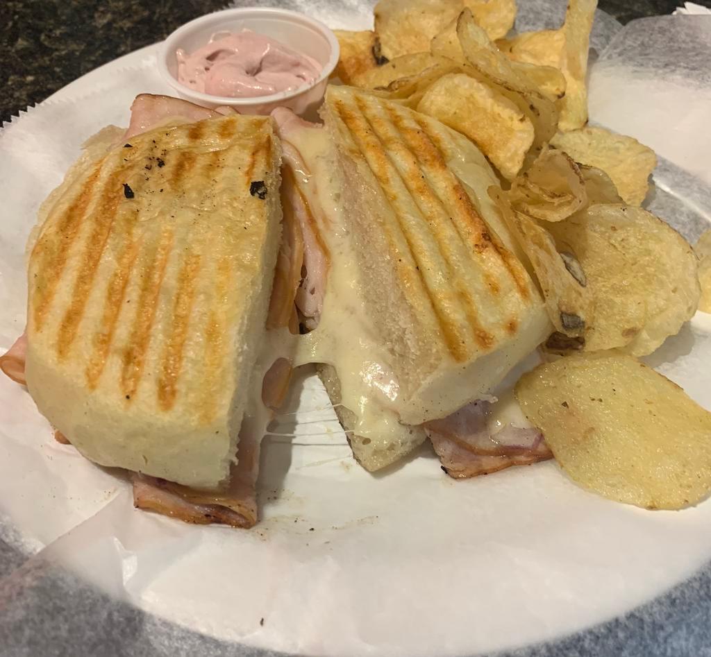 Bellevue Sandwich · Combo of turkey and cranberries. Smoked turkey, onions and Swiss cheese grilled on homemade ciabatta roll. Served with homemade cranberry cream cheese and chips.