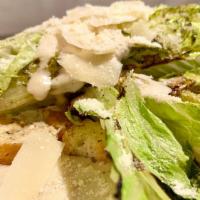Grilled Romaine  · Shaved Grana Padano, Creamy Caesar dressing, Herbed croutons