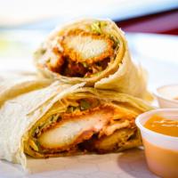 Spicy Fried Chicken Burrito · Made with deep-fried chicken tenders, spicy chipotle sauce, melted queso, sour cream and let...
