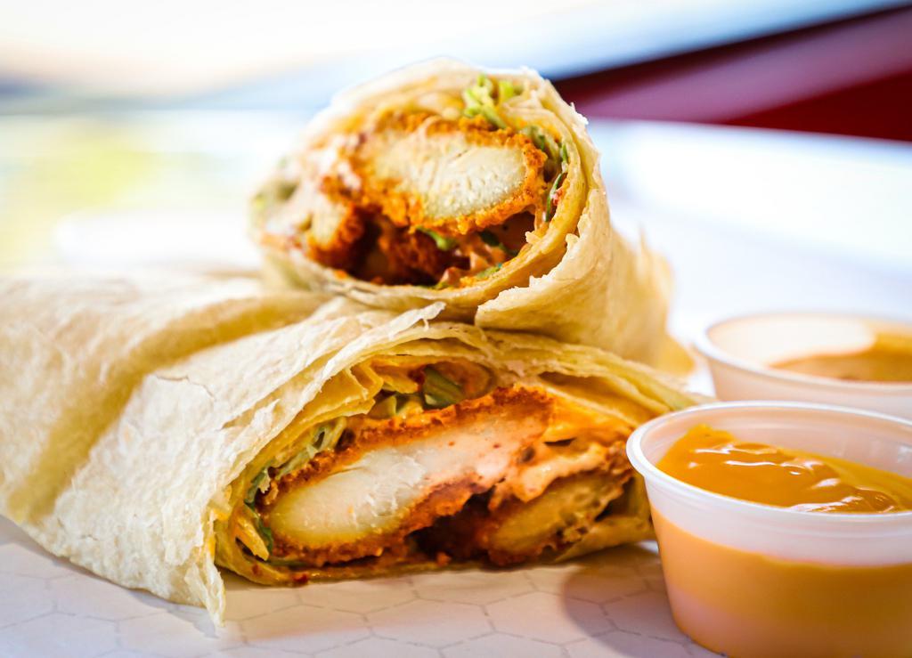 Spicy Fried Chicken Burrito · Made with deep-fried chicken tenders, spicy chipotle sauce, melted queso, sour cream and lettuce.