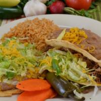 1. Beef Toastada and Beef Taco · Bean tostada, beef taco lettuce and cheese. served with rice and beans.