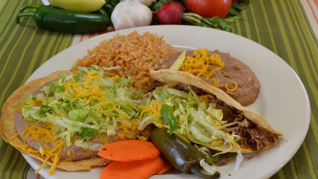 1. Beef Toastada and Beef Taco · Bean tostada, beef taco lettuce and cheese. served with rice and beans.