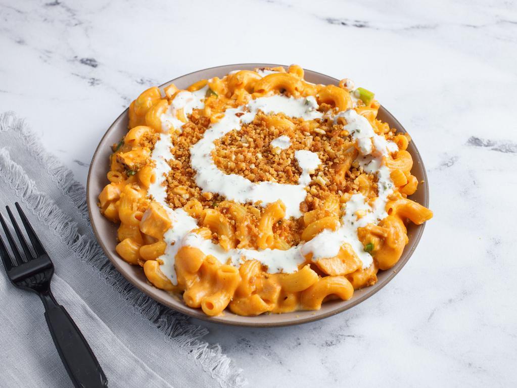 Buffalo Chicken Mac · All of the flavor with none of the mess. Grilled chicken, sharp cheddar, jack cheese, scallions and buffalo sauce. Topped with crispy breadcrumbs and homemade ranch. Contains gluten, dairy, and nightshades. We cannot make substitutions.