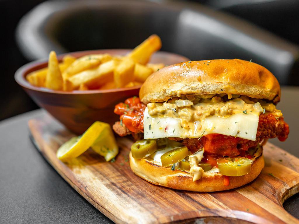 Fire Chicken Sandwich  · Grilled or deep-fried chicken breast, drizzled with our housemade fire sauce with melted jack cheese, sauteed jalapenos and blue cheese on a sesame bun 