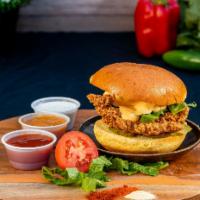 Fried Chicken Sandwich · Fried chicken thigh, potato bun, shredded lettuce, house made pickles and house sauce.

Alle...