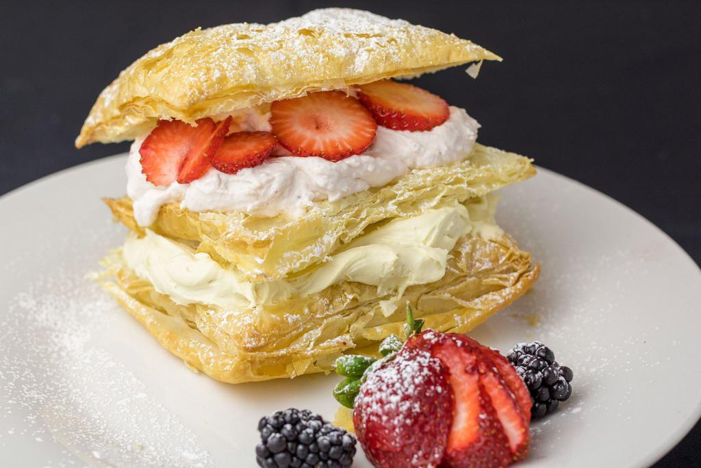 Napoleon · Three layers crispy pastry, filled with yummy vanilla and strawberry custard, seasonal berries, powdered sugar coated.