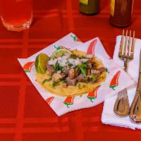 Lengua Taco · Served with lettuce, tomato, cilantro, onion, and cheese.