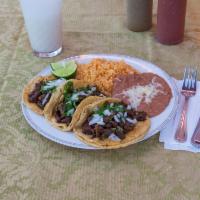 Taco Dinner · Choice of filling. Served with rice and beans, cheese and sour cream.