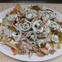 Nachos · Pick Grilled chicken or Ground Beef - Tomato, Lettuce, Onion, Jalapenos , Queso with Sour cr...