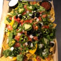 Super Nachos · Q’s legendary nachos, tortilla chips, topped with quest, onion, tomato, black olives, jalape...