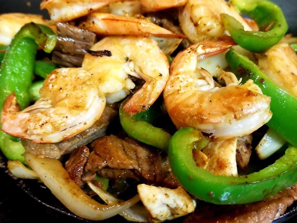 Fajita Mixta · Shrimp, beef and chicken. Includes green peppers and onions, served with side of rice, beans, pico de gallo, guacamole and tortilla.