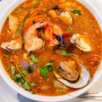 Sopa de Maricios · Seafood soup. Served with carrots, green peppers, onions, tomatoes and celery. Serve with si...