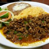 Bistec A La Mexicana · Mexican style steak chopped beef with onion tomatoes and jalapeno and red hot sauce.