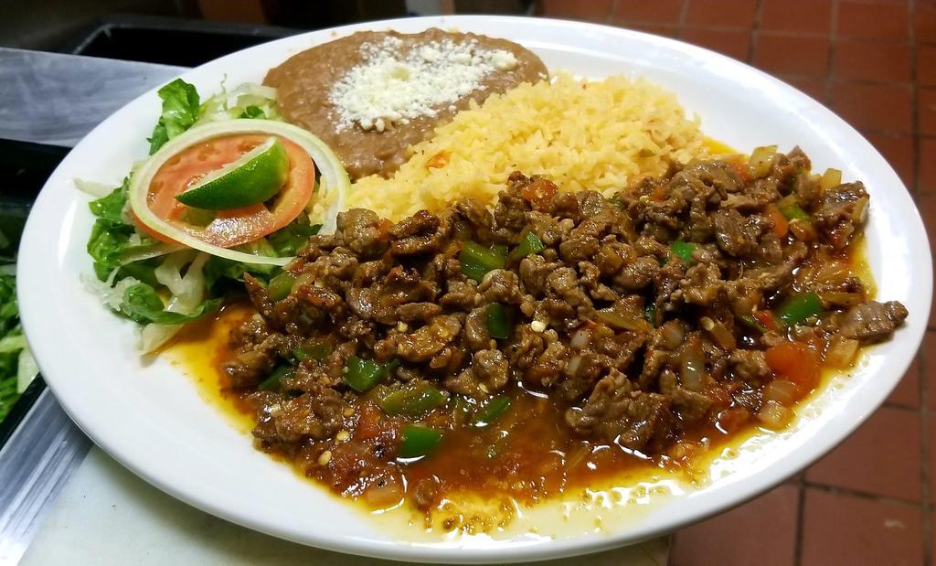 Bistec A La Mexicana · Mexican style steak chopped beef with onion tomatoes and jalapeno and red hot sauce.