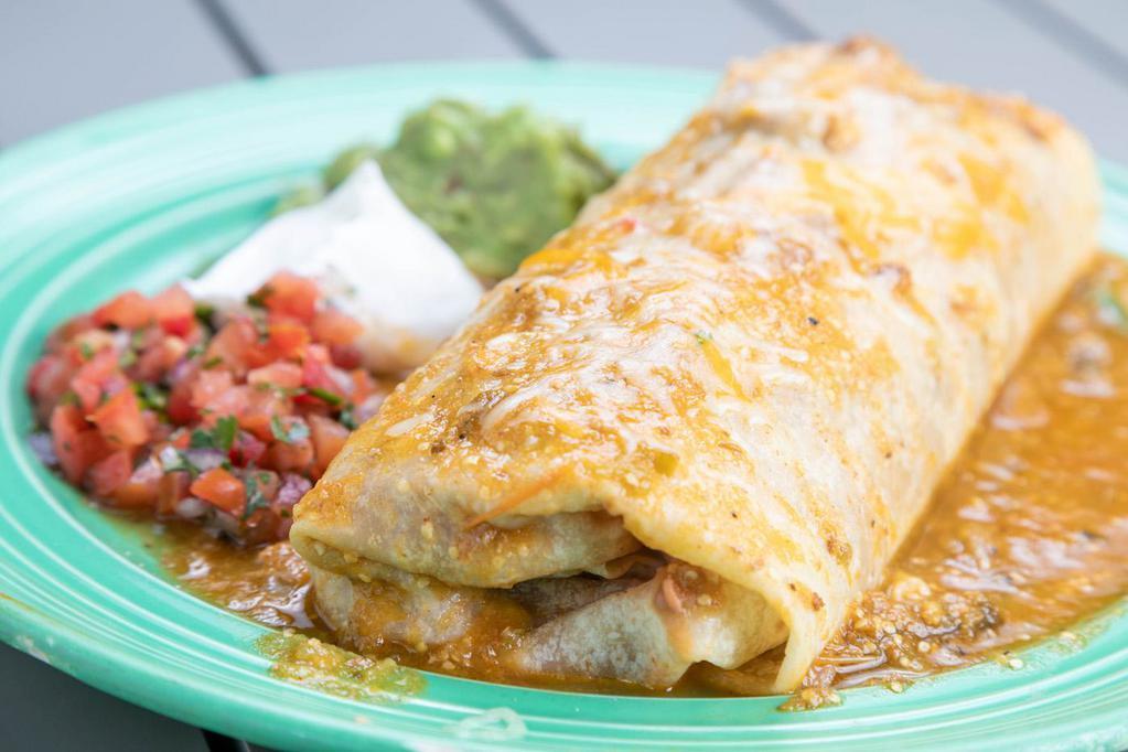 Chile Verde Burrito · Marinated Pork with onion and tomatillo salsa served with refried beans and Mexican rice and tortillas. 