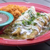 Chicken Enchiladas Suizas · Shredded chicken wrapped in flour tortillas, topped with our green sauce , crema fresca, que...