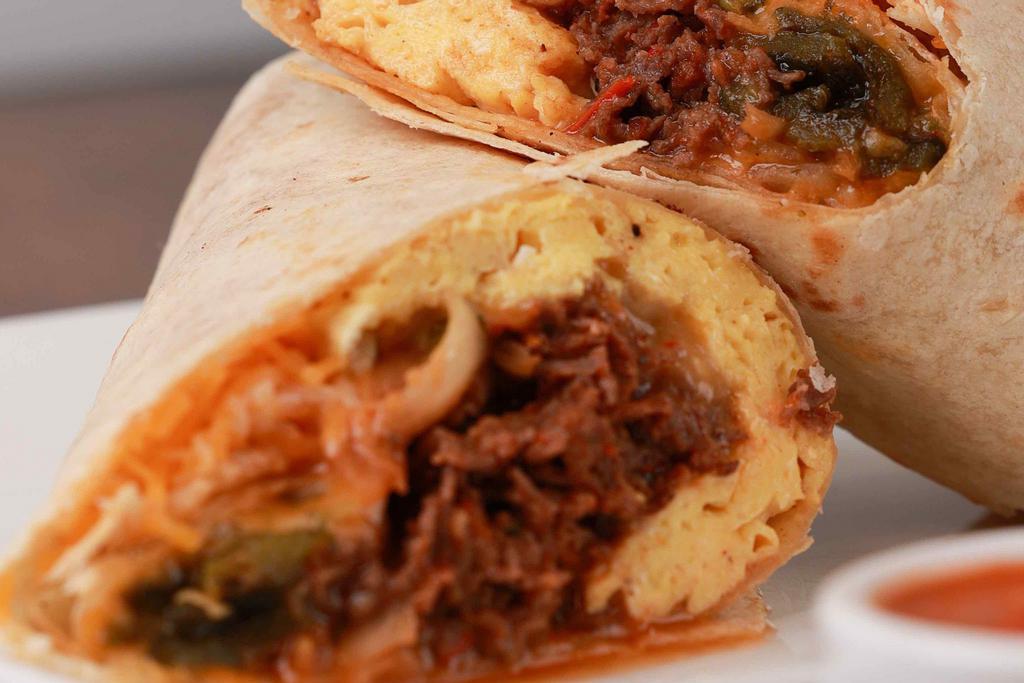 The CT Cruuunch · Eggs, ribeye steak, caramelized onions, poblano peppers, mushrooms in a spicy red salsa and cheddar jack cheese rolled in a flour tortilla wrap. Served with hot sauce.