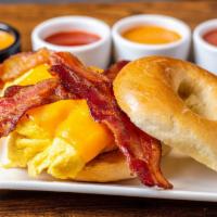 All American Bagel Sandwich · Eggs, bacon, melted cheddar cheese on a toasted plain bagel.