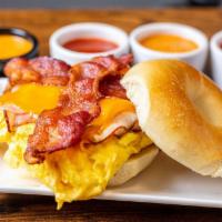 Ms. Piggy Bagel Sandwich · Eggs, bacon, ham and melted American cheese on your choice of toasted bagel.